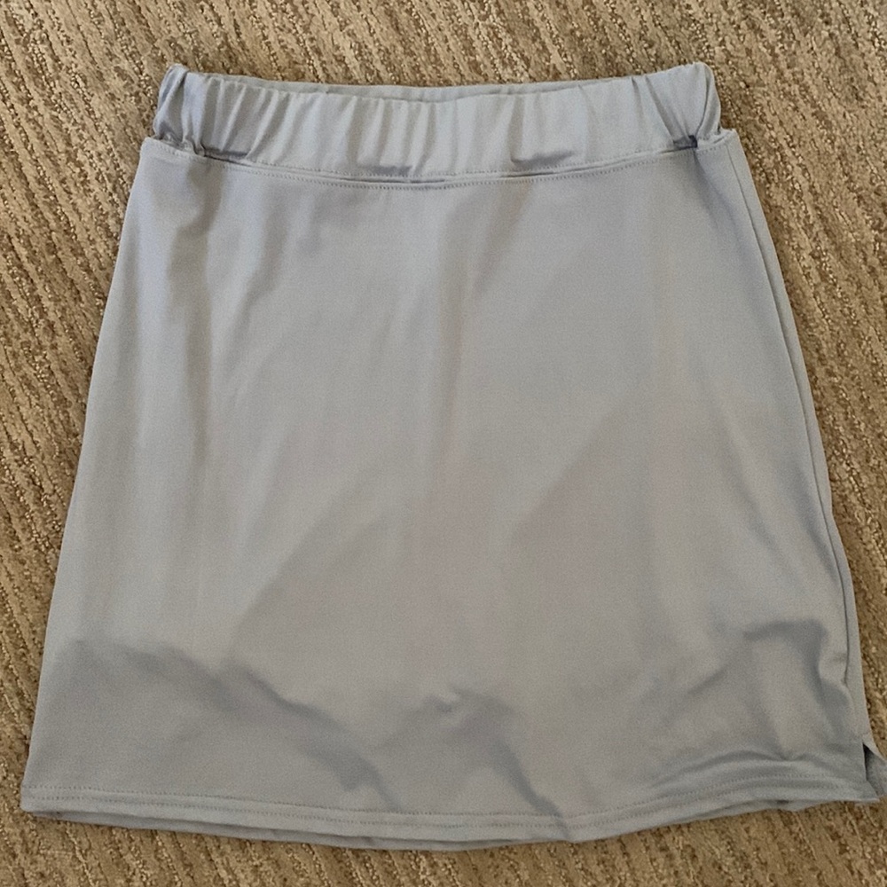 Silver Skorts. Slits on sides. Size Medium. 100% Polyester. Made in China.